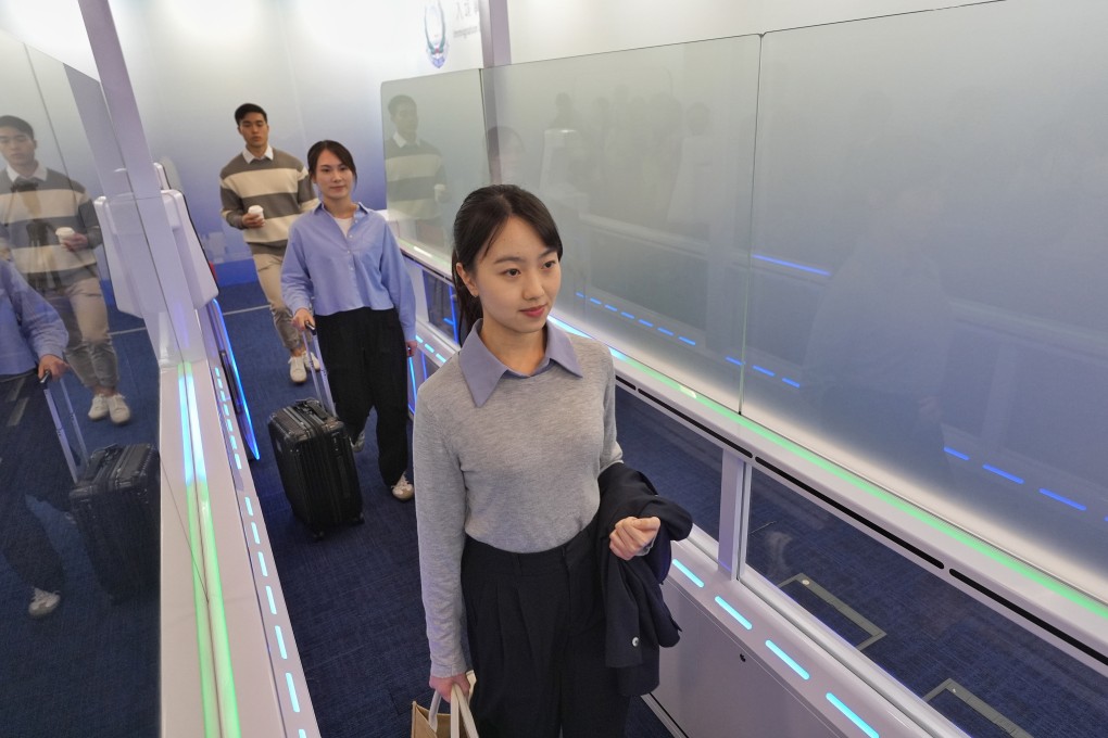 Participants demonstrate crossing the new e-channel system. Photo: Elson Li