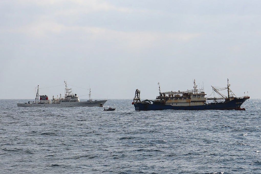 Japan’s Fisheries Agency says this photo taken on February 12 shows a patrol vessel, Hakuo Maru (left), and a Chinese fishing vessel sailing within Japan’s exclusive economic zone off Nagasaki prefecture. Photo: AFP