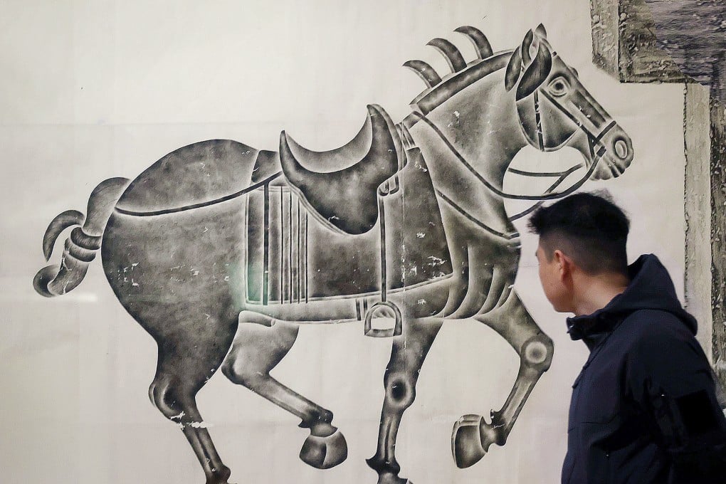 A patron passes the “Celebrating the Year of the Horse” exhibition at The Art Museum at The Chinese University of Hong Kong, on January 23. Photo: Jonathan Wong