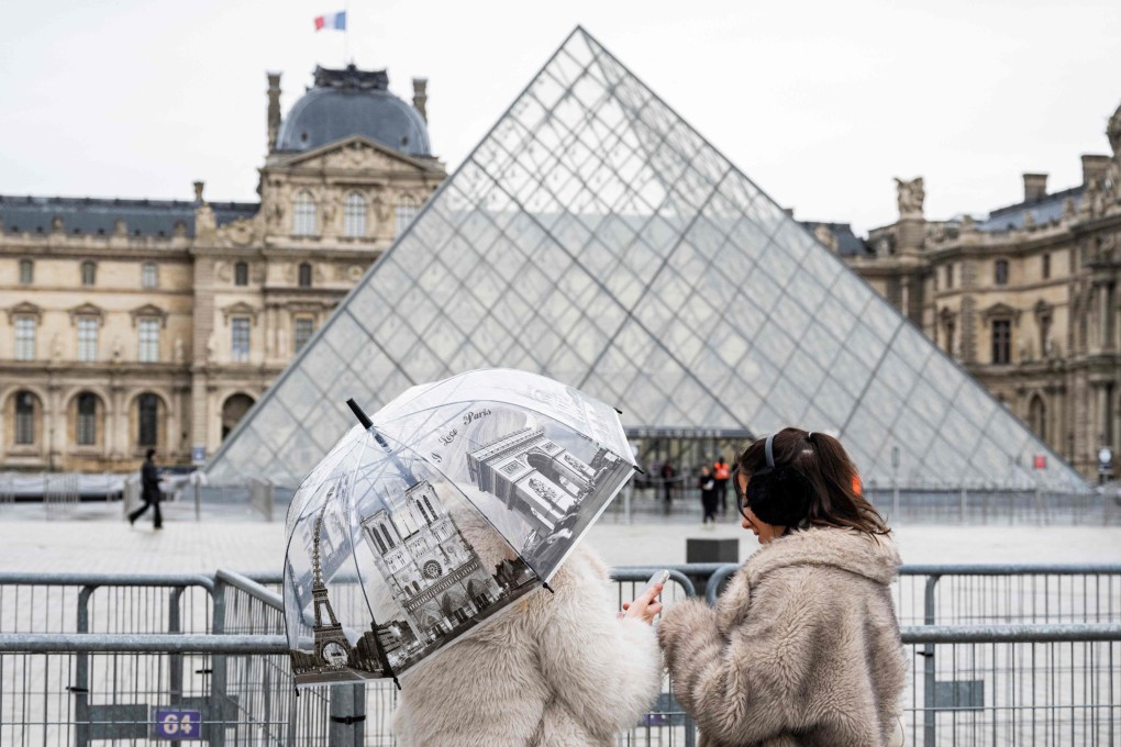 Tourists near the Louvre Pyramid in Paris. Photo: AFP