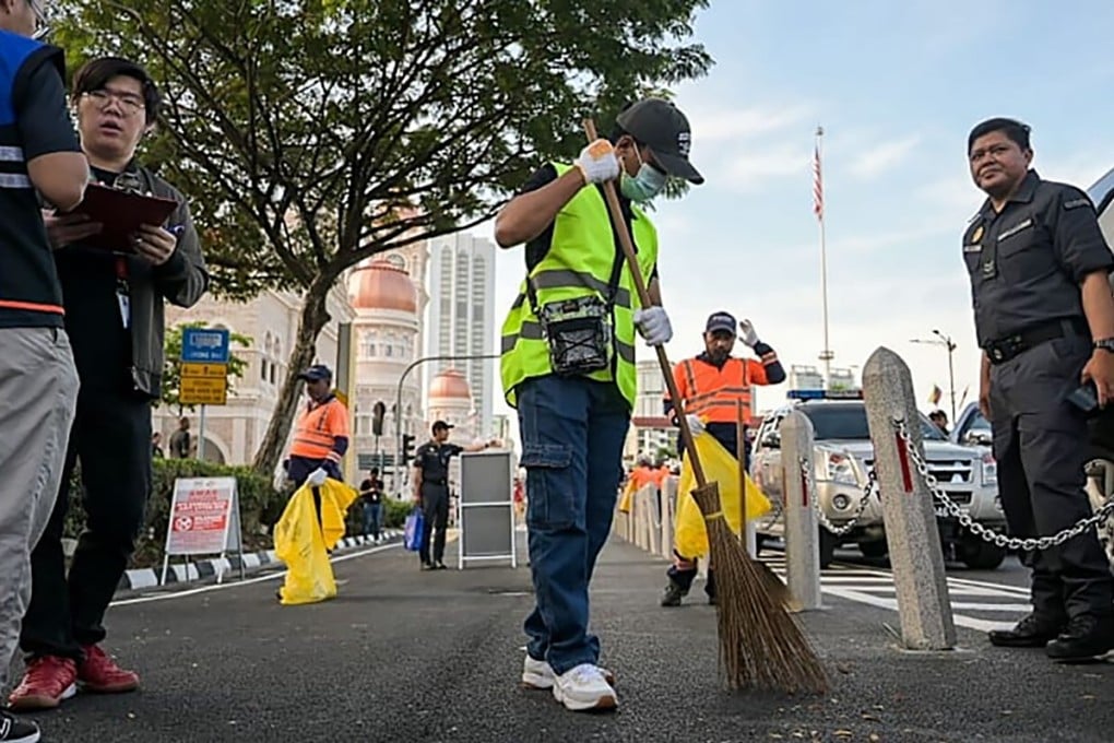 Mohamed Nuh Qurasaini Kayat serves his court-ordered community service sentence at Dataran Merdeka, Kuala Lumpur, on Friday. Photo: CNA
