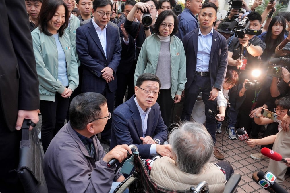 John Lee visits residents displaced by the Wang Fuk Court fire temporarily staying in a youth hostel in Kai Tak. Photo: Elson Li