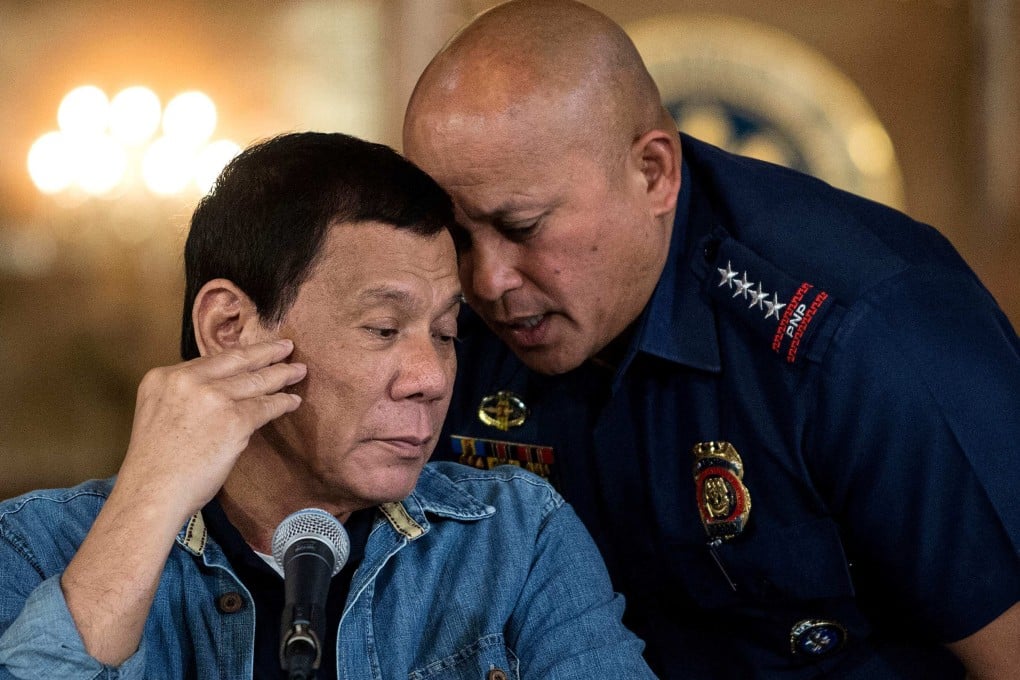 Former Philippine president Rodrigo Duterte listens to then police director general Ronald Dela Rosa during a press conference on  January 30, 2017. Photo: AFP