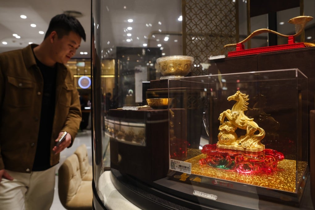 Decorative items made of gold are displayed at a jewellery store in Beijing on January 28. Photo: EPA-EFE