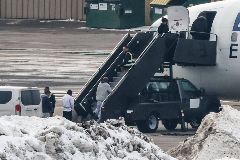 Shackled deportees board a plane at the Minneapolis-Saint Paul International Airport on February 5. Photo: AFP