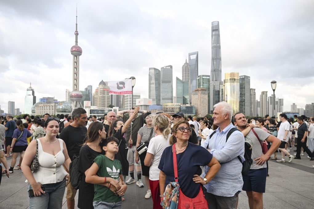 Foreign tourists take in the sights in the Bund area of Shanghai. Photo: Xinhua