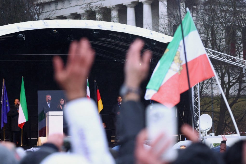 Demonstrators raise their hands as Reza Pahlavi, the exiled son of Iran’s last shah, delivers a speech in Munich, Germany, on Saturday. Photo: Reuters