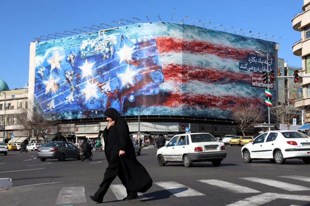 An Iranian woman walk near a huge anti-US billboard hanging at the Enqelab square in Tehran, Iran, on January 31. Photo: EPA-EFE