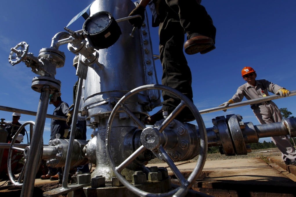 A Pertamina worker climbs on a gauge at a crude oil well on Bunyu island in Indonesia’s East Kalimantan province. Photo: Reuters
