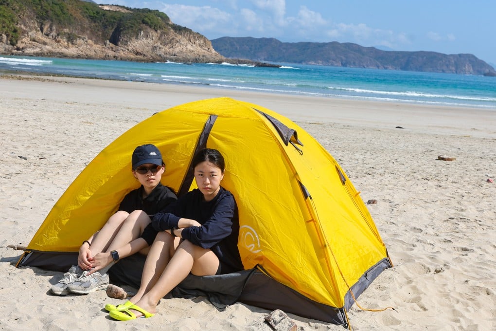Wu Handeng (left) and Jiang Li are camping on the beach. Photo: Edmond So
