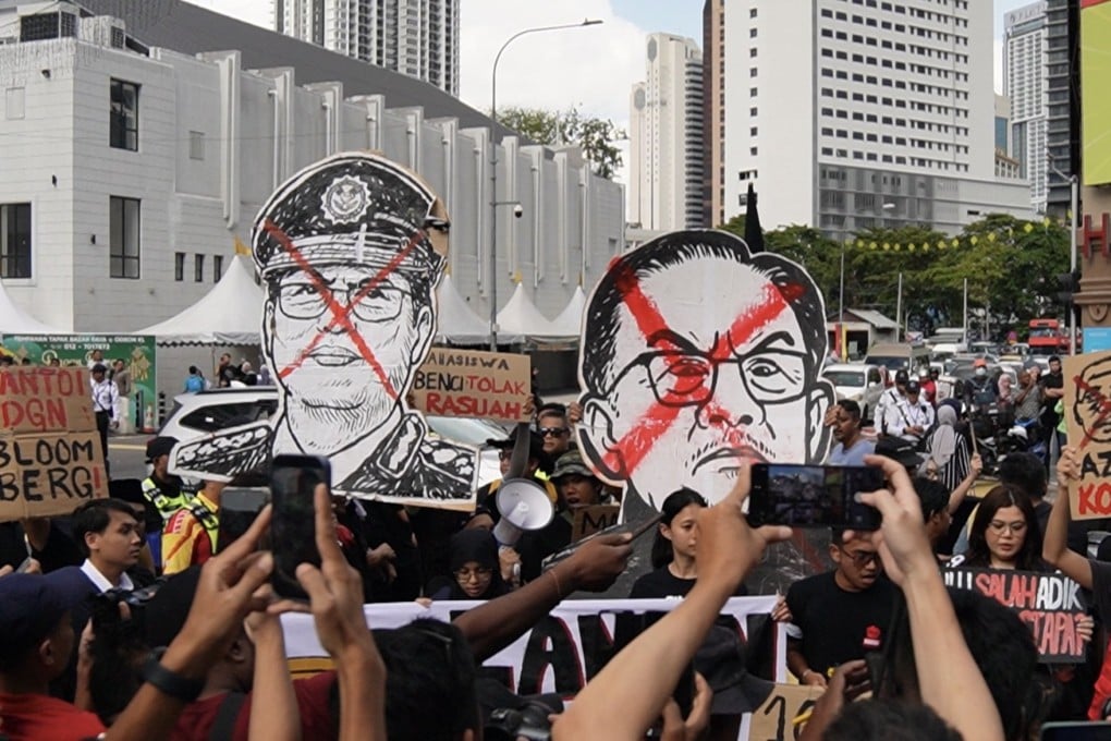 Malaysian protestors carry placards with the faces of MACC head Azam Baki (left) and Prime Minister Anwar Ibrahim on Sunday. Photo: X/Rafizi Ramli
