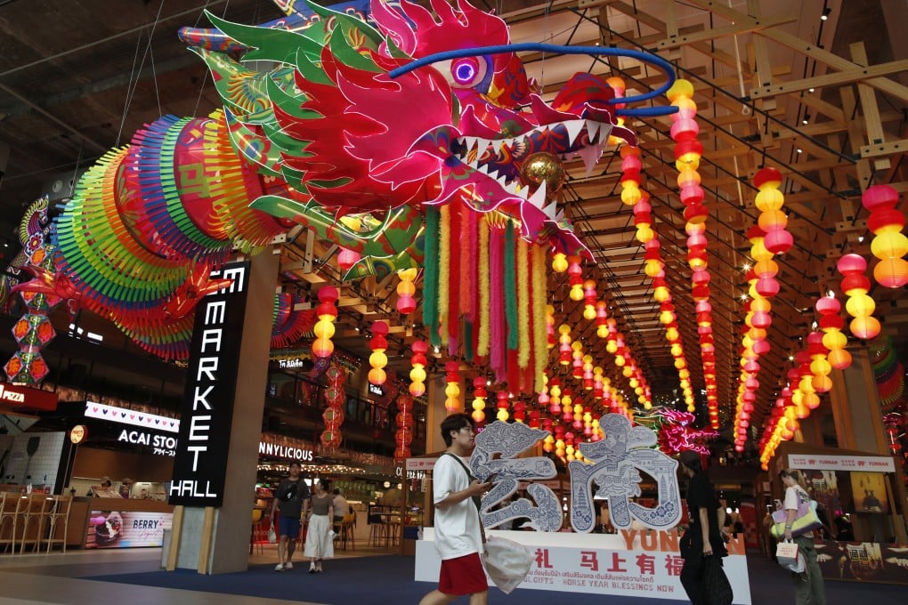People walk next to decorations ahead of the Lunar New Year’s Day at a shopping mall in Bangkok, Thailand, on Saturday. Photo: EPA-EFE