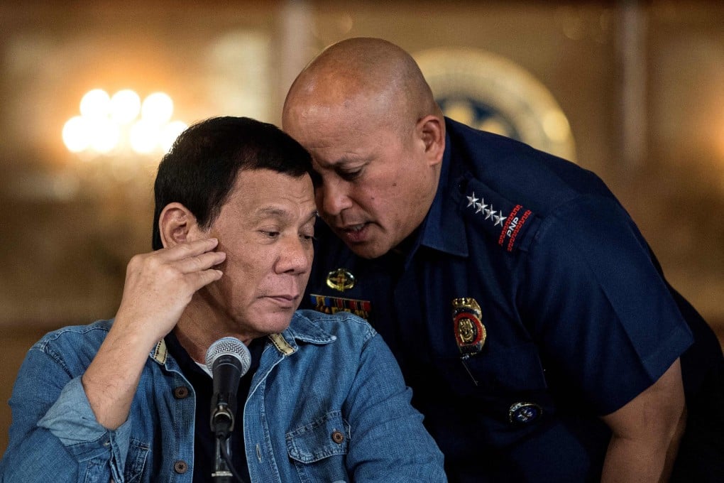 Philippines’ Rodrigo Duterte (left) listening to Ronald Dela Rosa, then director general of the Philippine National Police, during a press conference at the Malacanang palace in Manila in 2017. Photo: AFP