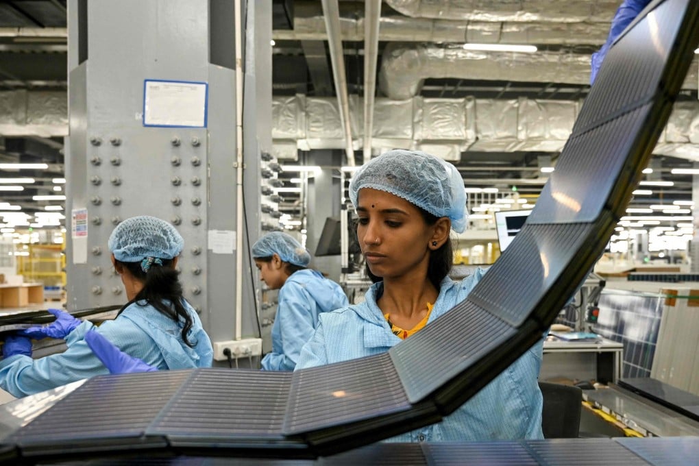 Employees inspect photovoltaic cells used in solar panels at an Adani Group factory in Mundra, India, on November 5, 2025. Photo: AFP