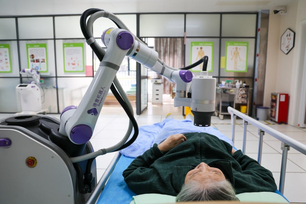 A robot conducts moxibustion therapy on an elderly resident at a nursing home in Shenzhen, China’s southern Guangdong province. Photo: Xinhua