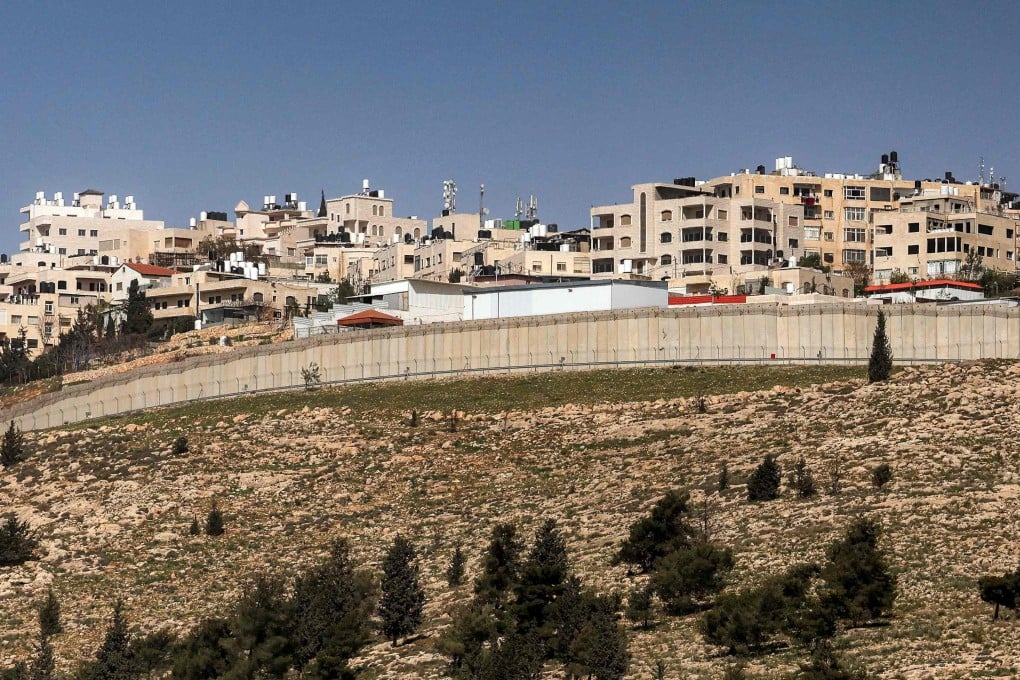 The West Bank village of al-Ram is seen behind Israel’s separation barrier from the outskirts of Jerusalem on Monday. Photo: AFP