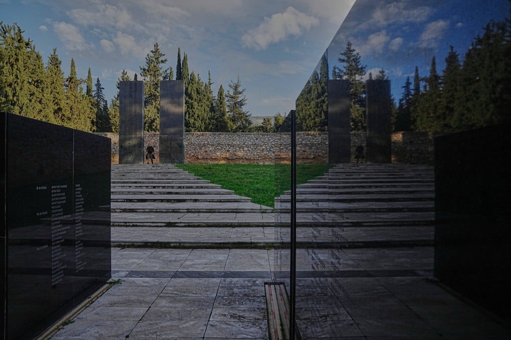 A man walks through a memorial site at the Kaisariani Shooting Range in Athens, Greece on Monday, the site where 200 Greek communist political prisoners were executed by Nazi forces on May 1, 1944. Photo: AP