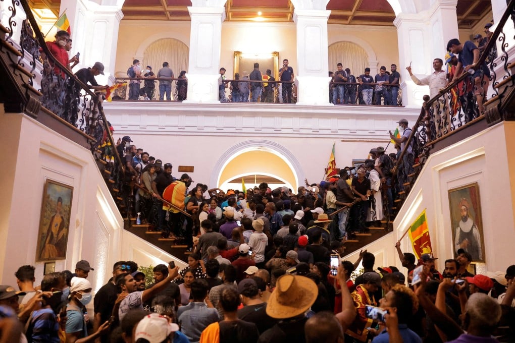 Demonstrators protest inside the President’s House in Colombo after president Gotabaya Rajapaksa  flees on July 9, 2022. Photo: Reuters