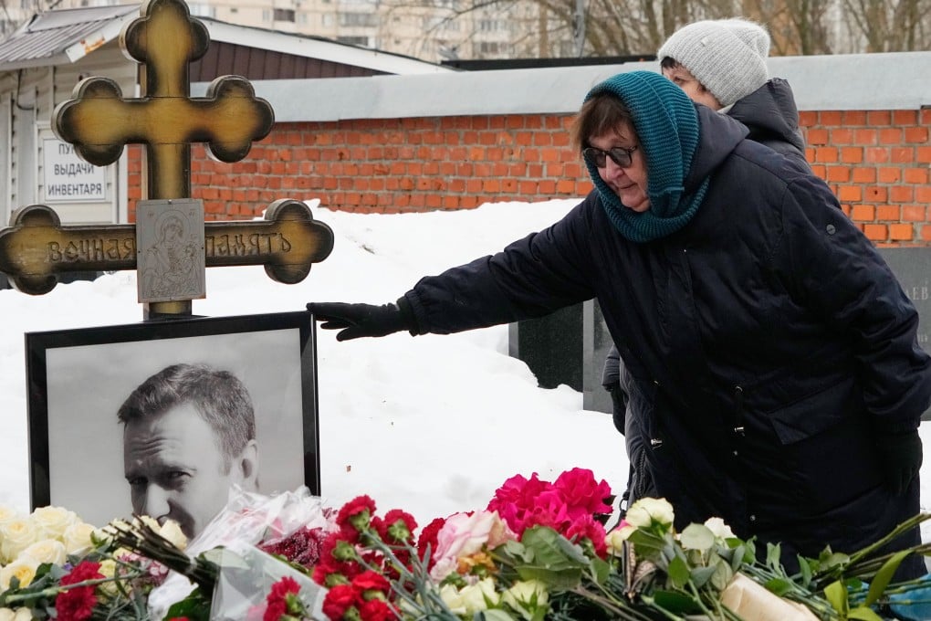Lyudmila Navalnaya touches the portrait of her son, Alexei Navalny, at his grave in Borisovskoye Cemetery, Moscow, on Monday. Photo: AP