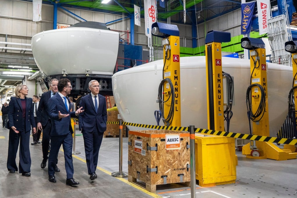 Prime Minister Mark Carney (right) tours CAE Inc facilities in Montreal on Tuesday. Photo: The Canadian Press via AP