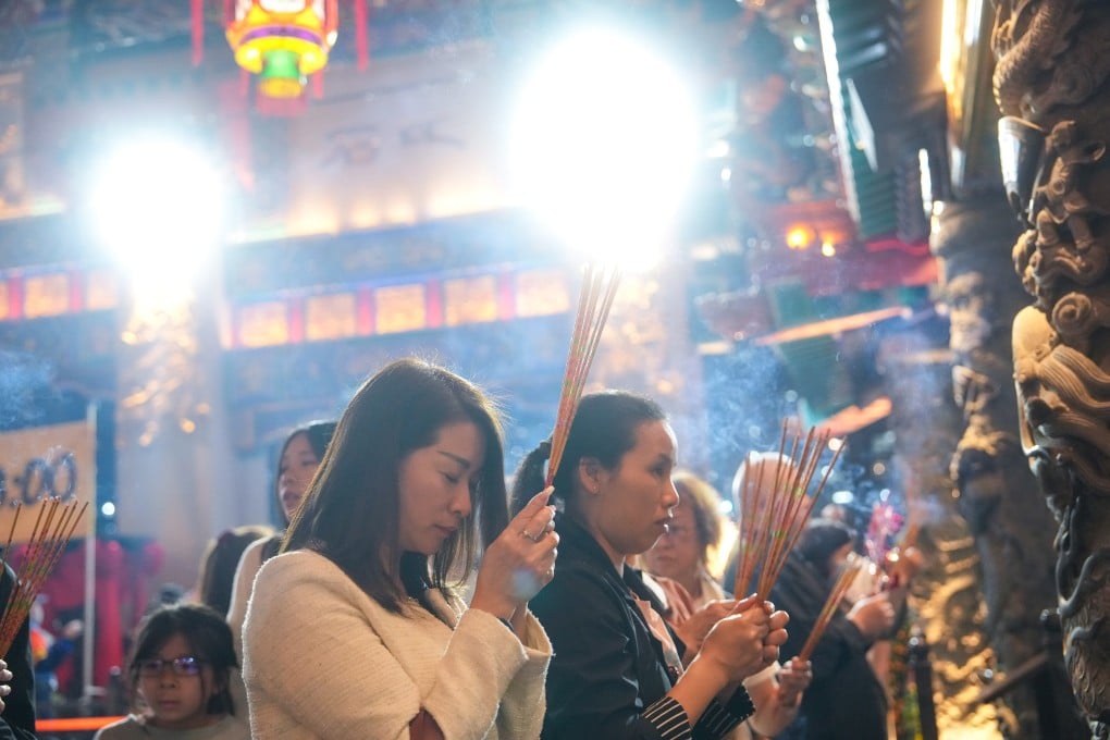 Worshippers visit the Wong Tai Sin Temple in Hong Kong on Monday to pray for good luck in the Year of the Fire Horse. Photo: Sam Tsang