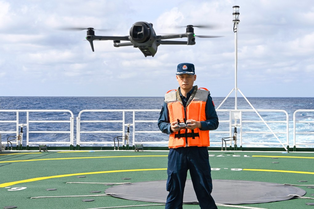 Qiu Canhui operates a drone aboard the Chinese coastguard vessel Wanshan near Scarborough Shoal in the South China Sea on February 11. Photo: Xinhua