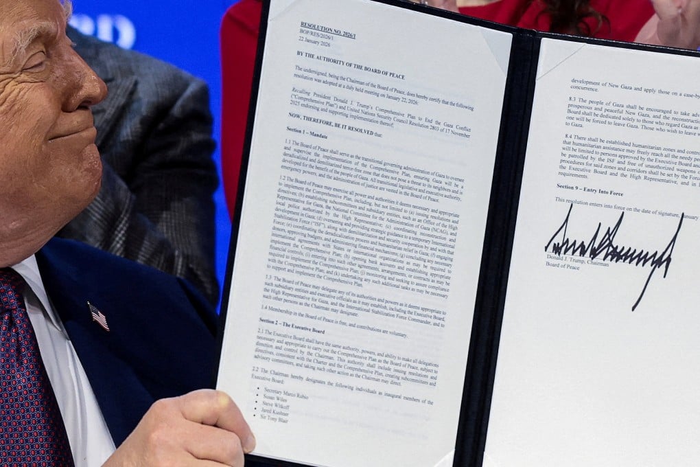US President Donald Trump holds a signed resolution at the “Board of Peace” charter announcement in Davos on January 22. Photo: Reuters