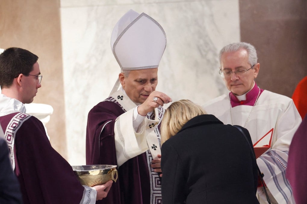 Pope Leo XIV puts ash on the head of one of the faithful during the Ash Wednesday Mass at the Santa Sabina Basilica in Rome. Photo: Reuters