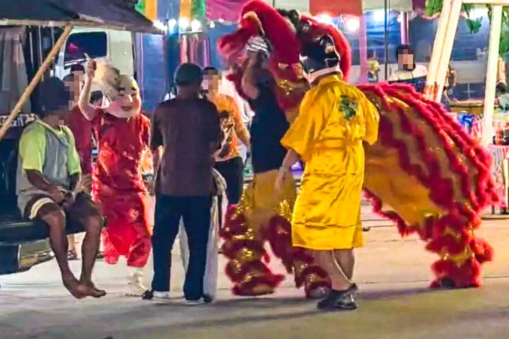 Disguised as a lion dance troupe, Thai police home in on the man in a brown T-shirt. Photo: Handout