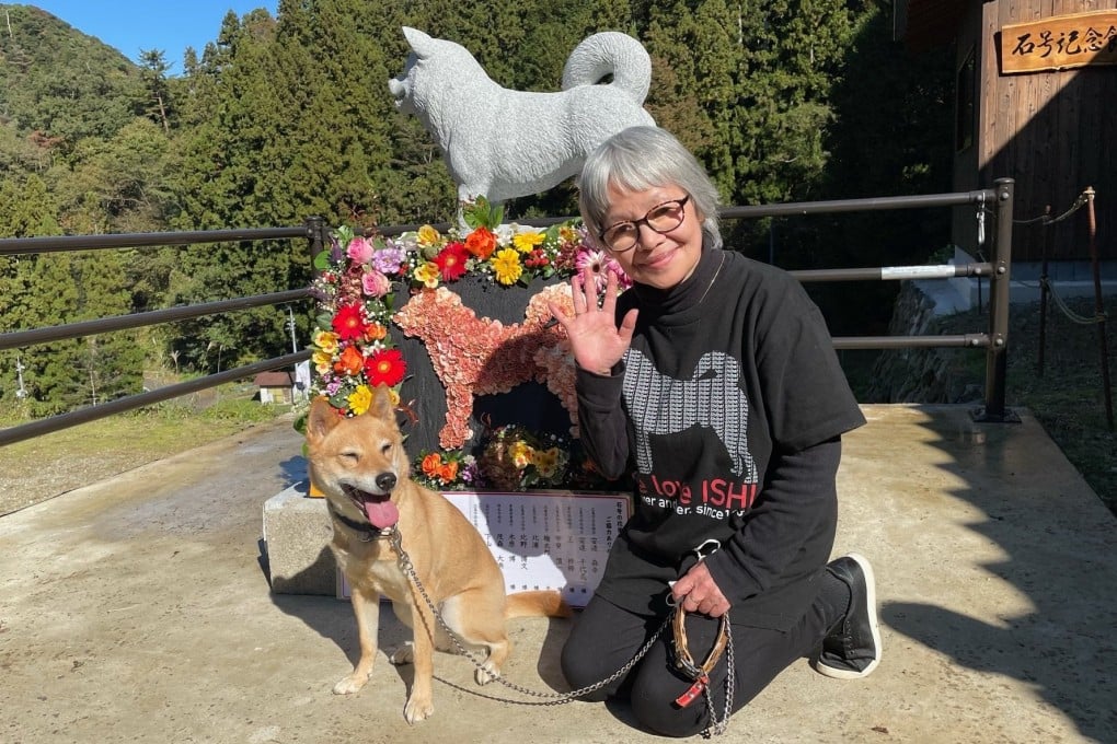 Mayumi Kawabe smiles in front of the stone statue of Ishi Go, an early ancestor of today’s Shiba Inu breed, in Masuda, Shimane, Japan. At the end of 2016, she welcomed Sunny, a two-month-old puppy, into her home. Photo: Kyodo