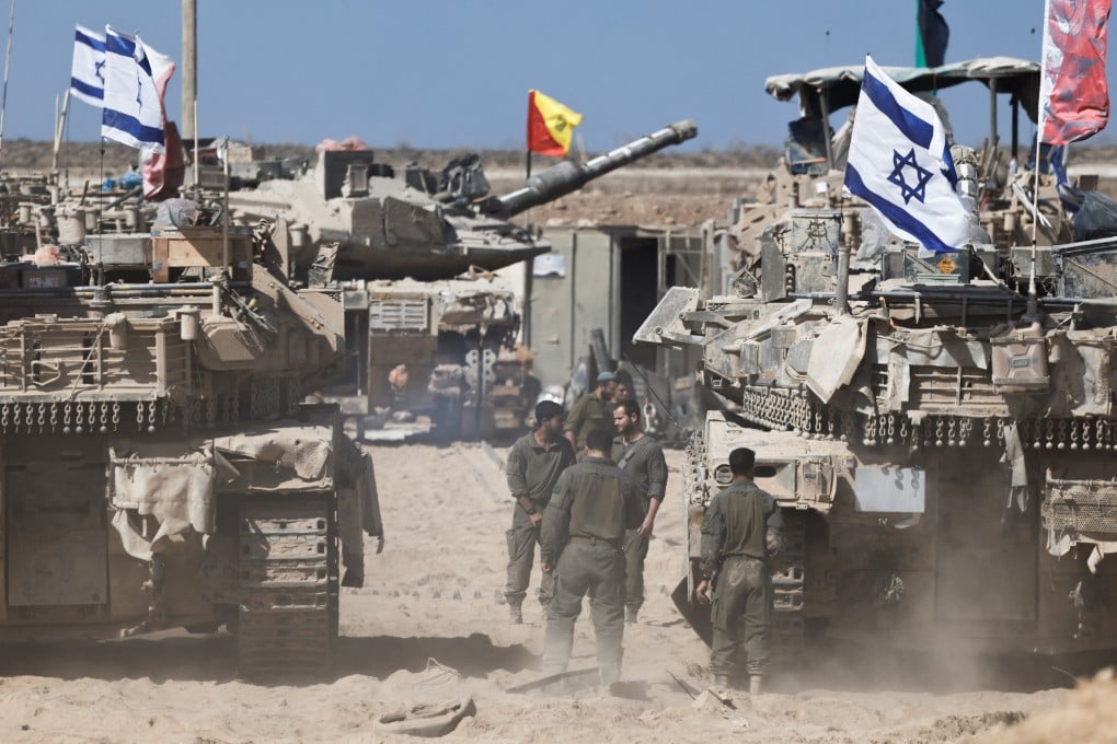 Israeli soldiers stand next to tanks near the Israel-Gaza border in October last year. Photo: Reuters
