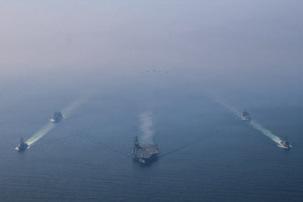 The USS Abraham Lincoln, flanked by guided-missile destroyers and other support vessels, during a photo exercise in the Arabian Sea on February 6. Photo: US Navy via AFP