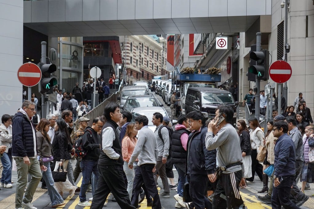 People at a pedestrian crossing in Central. How will the coming budget benefit ordinary Hongkongers? Photo: Karma Lo
