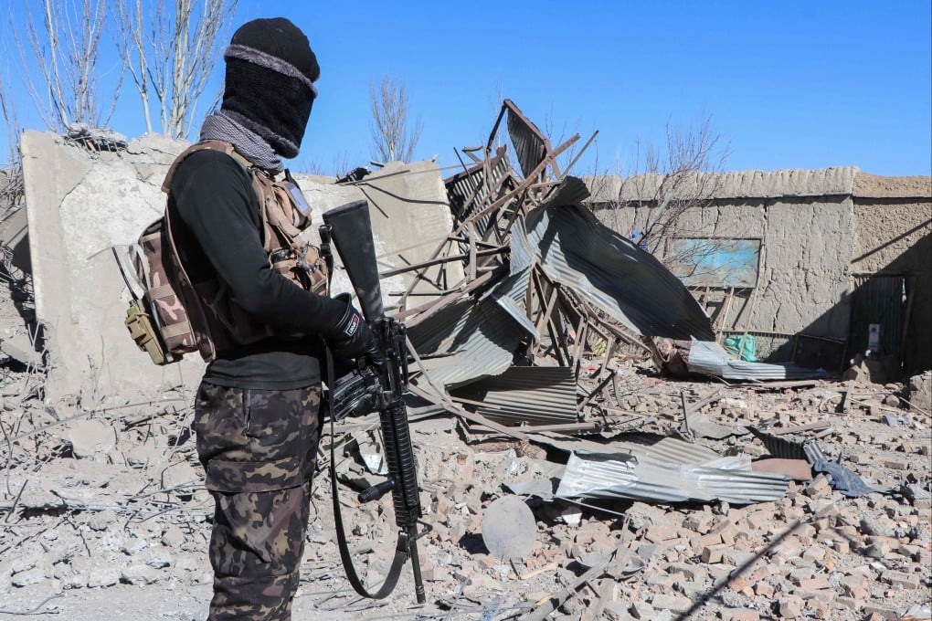 Taliban security personnel stand guard next to the debris of houses destroyed during an overnight Pakistani airstrike at the Balish village in Urgun district, Paktika Province, Afghanistan on Sunday. Photo: AFP
