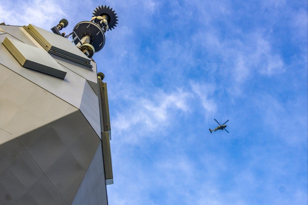 A Royal Australian Navy helicopter flies above the HMAS Toowoomba as it sails in the South China Sea. Photo: Handout
