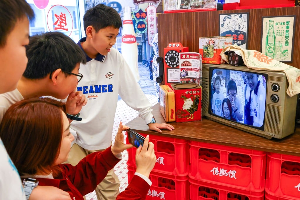 Tourists gather around an old-school display at a Wellcome supermarket in Hong Kong’s Yau Ma Tei neighbourhood. Similar retro-themed displays are popping up all over the city. Photo: Dickson Lee
