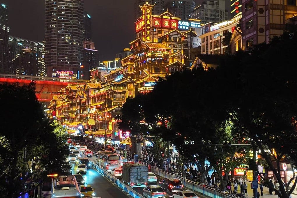 Jiefangbei Pedestrian Street in Chongqing bursts into neon splendour at night, with Hongya Cave - a sprawling “stilt building” complex that is one of the city’s most popular tourist attractions - glowing against the Chinese city’s skyscrapers. Photo: Evian Yu