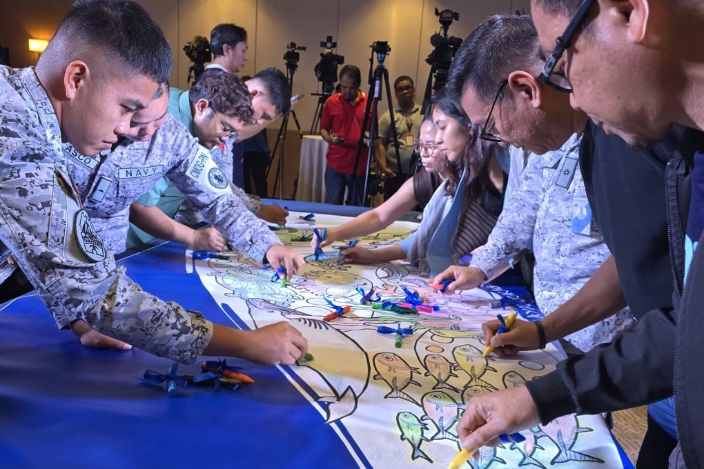 Members of the Philippine Navy take part in a collaborative colouring activity during the launch of the nationwide mural contest on February 10. Photo: Raissa Robles