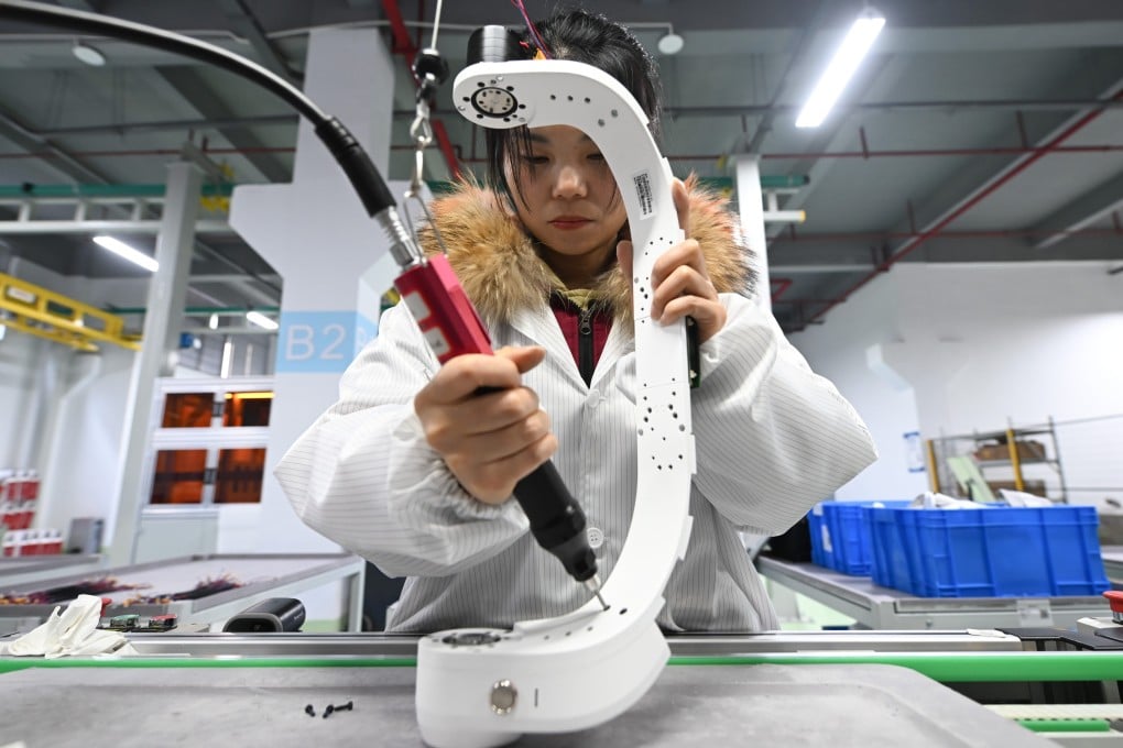 An employee works on the production line of the Tashan hip-assisted exoskeleton at a workshop in Hangzhou, capital of Zhejiang province. Photo: China News Service/VCG via Getty Images