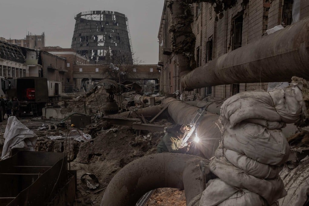 Ukrainian workers repair sections of a power plant damaged by Russian air strikes. Photo: AFP