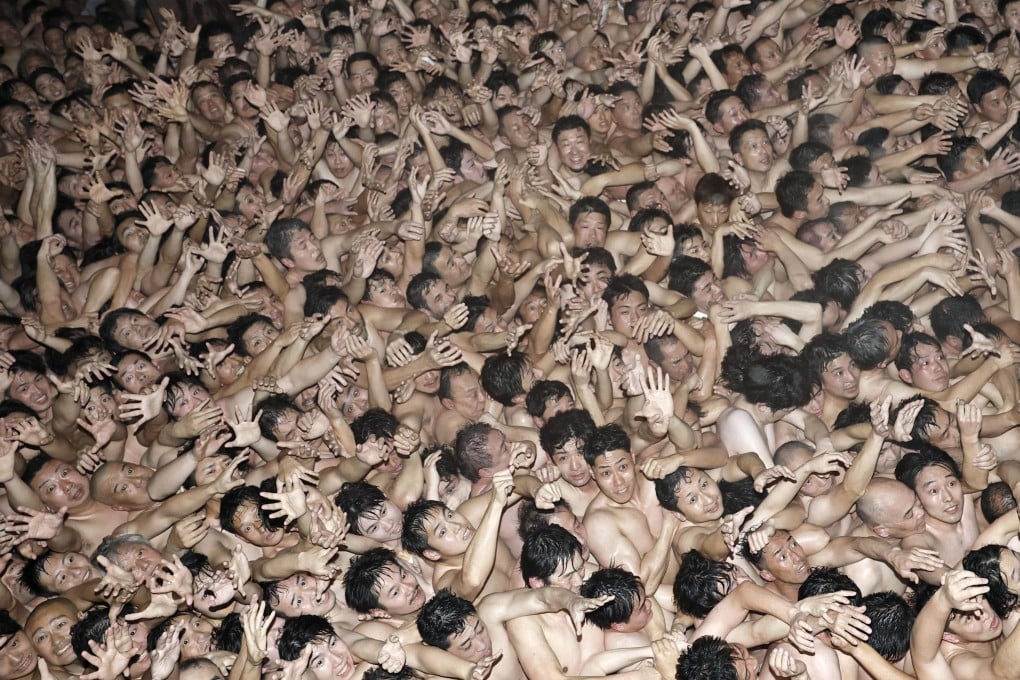 Participants at the Saidaiji “naked festival” gather inside the temple hall before sacred talismans are thrown in Okayama City on Saturday. Photo: Kyodo