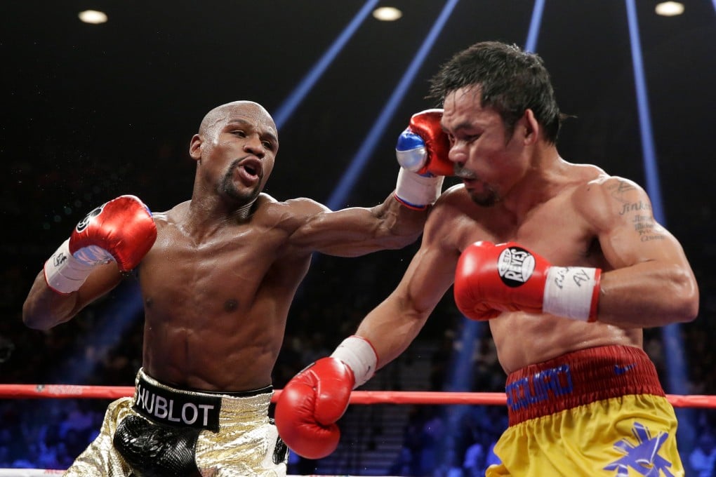 Floyd Mayweather (left) hits Manny Pacquiao during their 2015 welterweight title fight in Las Vegas. Photo: AP