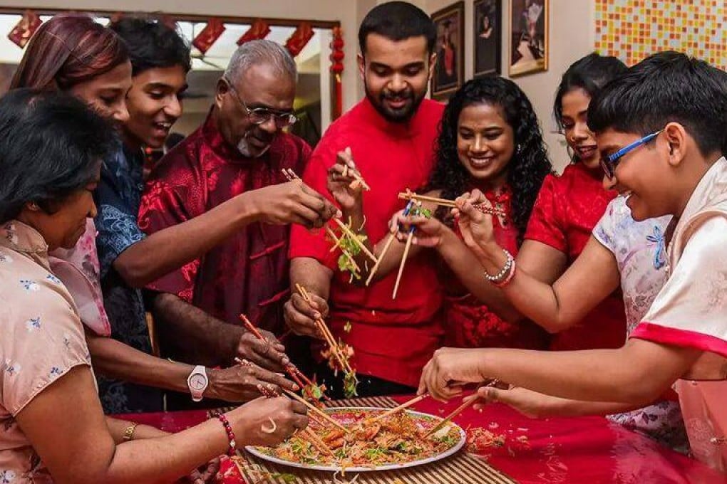 The Lourdes family take part in the traditional “yusheng” toss on Lunar New Year’s Eve. Photo: Alyssa Ann Lourdes