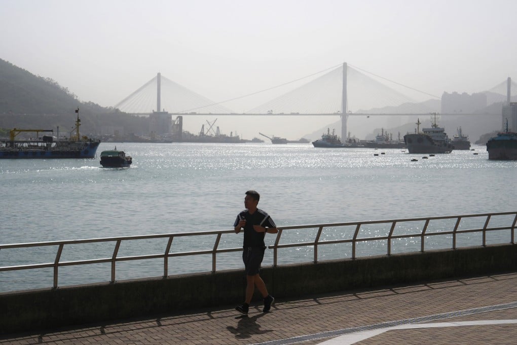 A man jogs along the Tsuen Wan Promenade, with Ting Kau Bridge in the background, on April 15. Photo: Elson Li