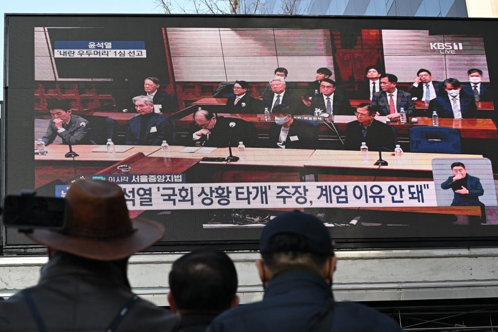 Supporters of former South Korean president Yoon Suk-yeol (second row, left) watch a live stream of his trial on Thursday. Photo: AFP