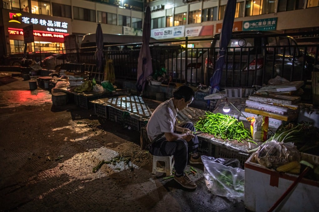 A man sits next to pepper at a market in Ganluo County, Sichuan, China. The province is considered as one of China’s most poverty-stricken areas. Photo: EPA-EFE