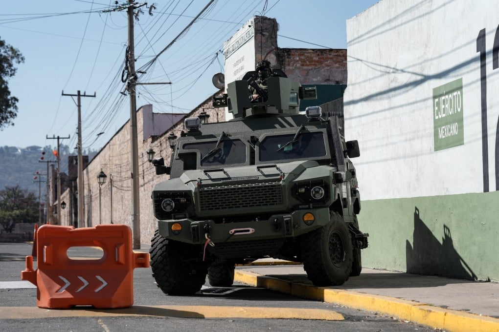 A soldier atop an armoured vehicle outside a military facility in Morelia, Mexico. Photo: Reuters