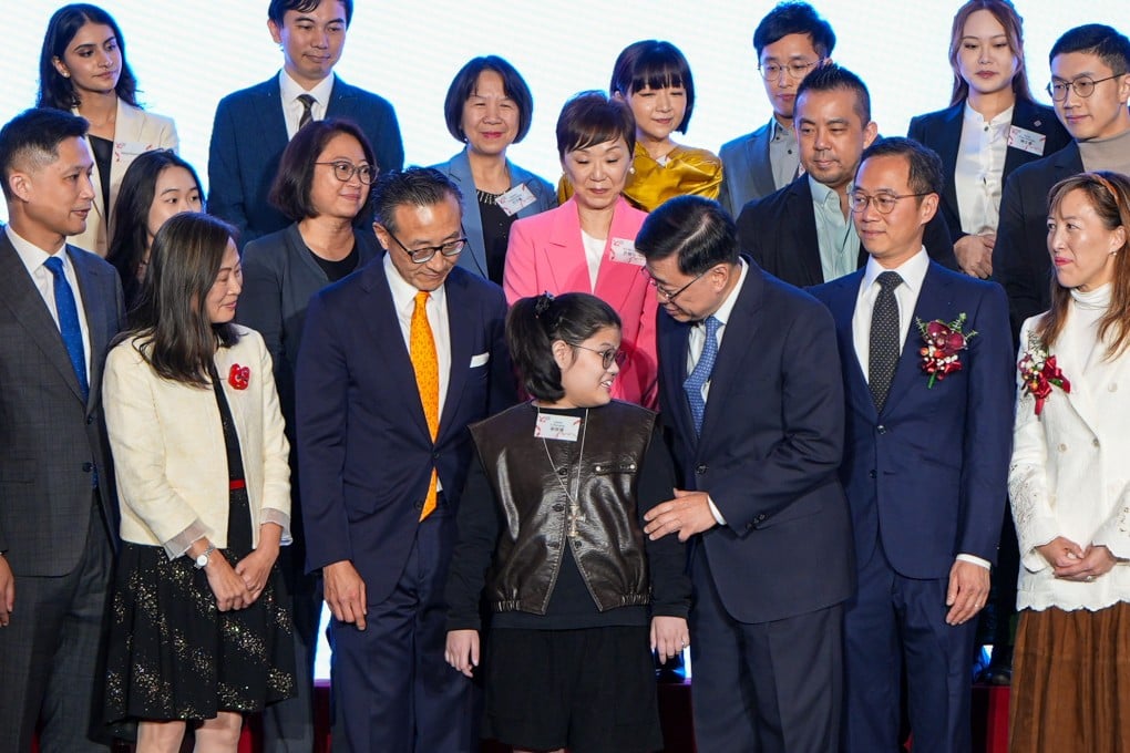 (Front row, from left) Fire services chief Andy Yeung, the SCMP’s Tammy Tam, Alibaba’s Joe Tsai, perseverance award finalist Cassie Li, Chief Executive John Lee, Ocean Park’s Paulo Pong and Sino Group’s Nikki Ng with other finalists and guests at the ceremony. Photo: Eugene Lee