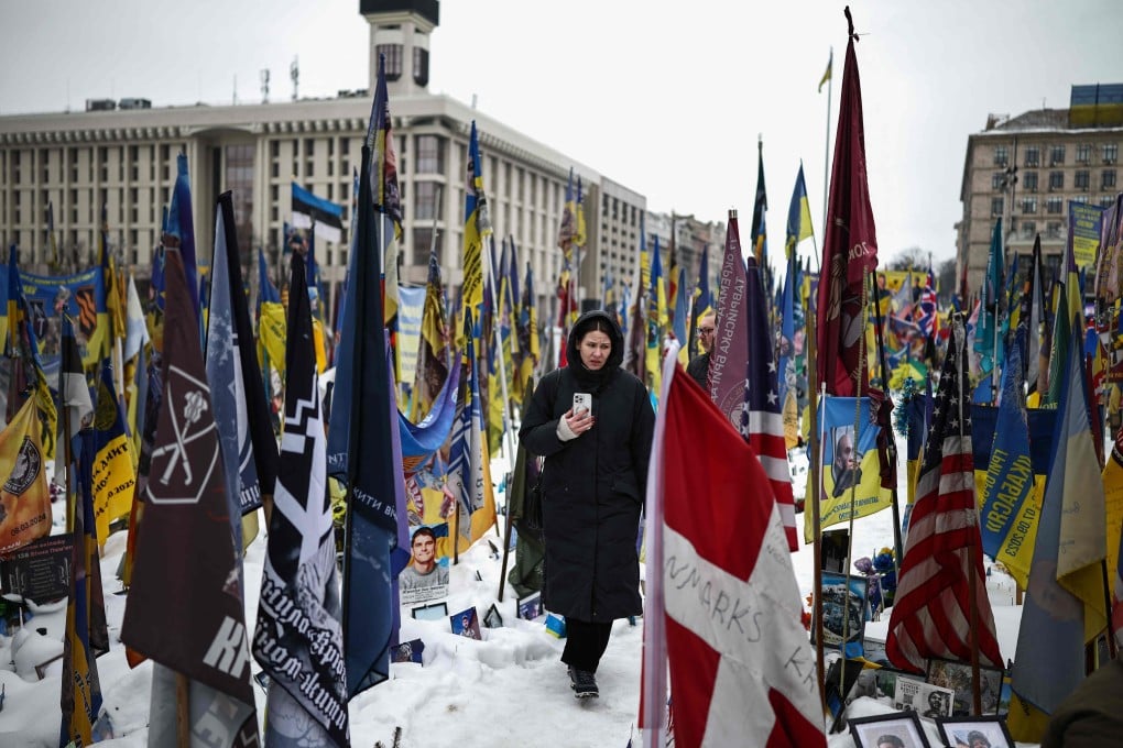 A person walks through a makeshift memorial to fallen soldiers in Kyiv, Ukraine on Monday, as the conflict with Russia reaches its four-year mark. Photo: AFP