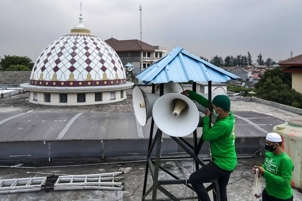 Officials inspecting a mosque’s speakers in Jakarta. Photo: AFP